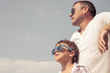 Image showing Father and son playing on the beach at the day time.