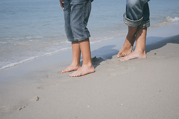 Image showing Father and son playing on the beach at the day time.