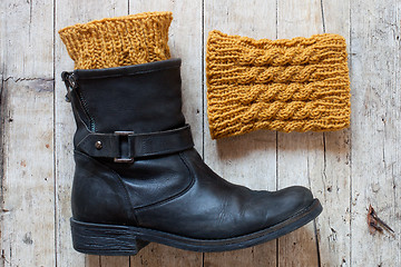 Image showing black leather boot and knitted wood legwarmers