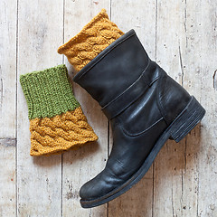 Image showing black leather boot and knitted wood legwarmers 