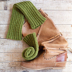 Image showing brown leather high boot and knitted green wood legwarmers