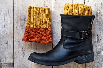 Image showing black leather boot and knitted wood legwarmers