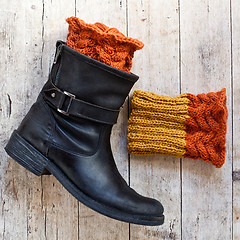 Image showing black leather boot and knitted wood legwarmers