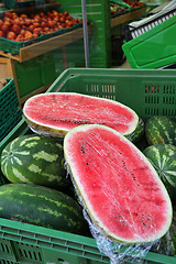 Image showing Halves of a large juicy ripe watermelon in the store 