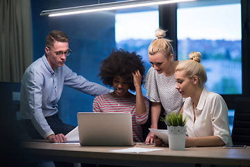 Image showing Multiethnic startup business team in night office