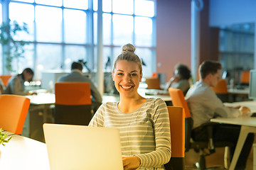 Image showing businesswoman using a laptop in startup office