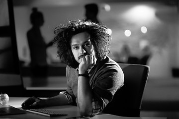 Image showing man working on computer in dark office