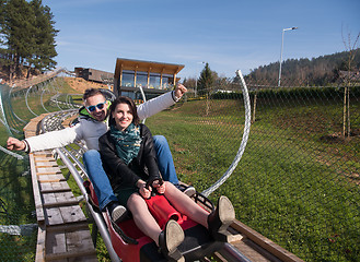 Image showing couple enjoys driving on alpine coaster