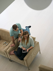 Image showing couple relaxing at  home with tablet computers