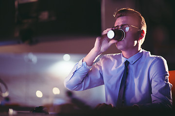 Image showing Tired businessman working late