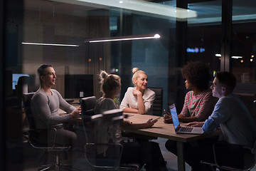 Image showing Multiethnic startup business team in night office