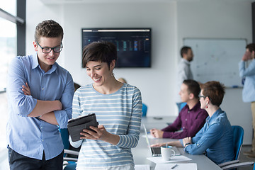 Image showing Two Business People Working With Tablet in office