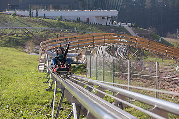 Image showing couple enjoys driving on alpine coaster