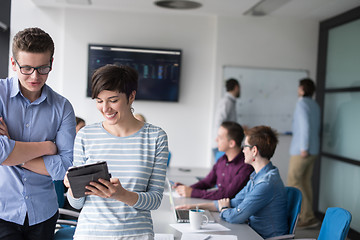 Image showing Two Business People Working With Tablet in office