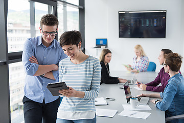 Image showing Two Business People Working With Tablet in office