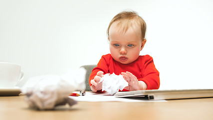 Image showing Happy child baby girl toddler sitting with keyboard of computer isolated on a white background