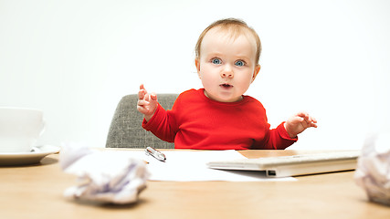 Image showing Happy child baby girl toddler sitting with keyboard of computer isolated on a white background