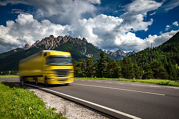 Image showing Fuel truck rushes down the highway in the background the Alps. T