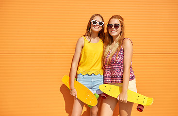 Image showing teenage girls with short skateboards outdoors