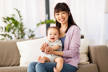 Image showing happy young asian mother with little baby at home