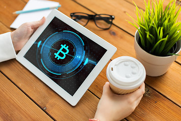 Image showing hands with bitcoin on tablet pc computer screen