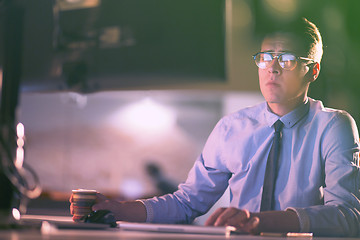 Image showing Tired businessman working late