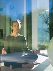 Image showing young woman doing morning yoga exercises