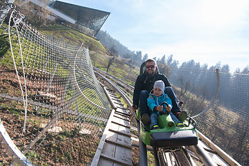 Image showing father and son enjoys driving on alpine coaster