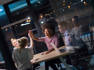 Image showing Multiethnic startup business team in night office