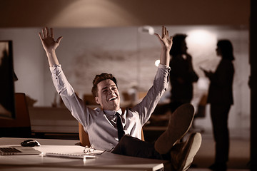 Image showing businessman sitting with legs on desk at office