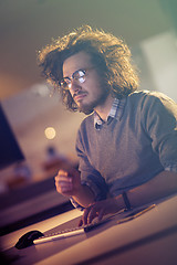 Image showing man working on computer in dark office