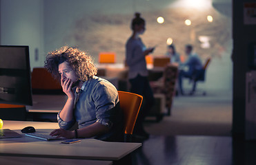 Image showing man working on computer in dark office