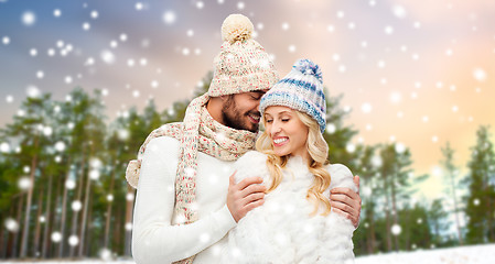 Image showing couple hugging over winter forest background