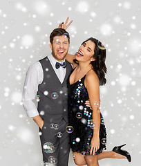 Image showing happy couple hugging in soap bubbles at party