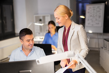 Image showing business team with papers working late at office