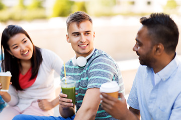 Image showing friends drinking coffee and juice talking in city