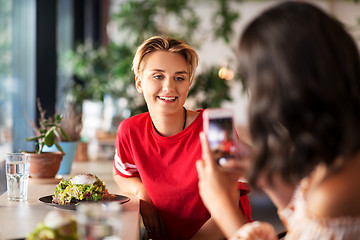 Image showing women having lunch and photographing at cafe