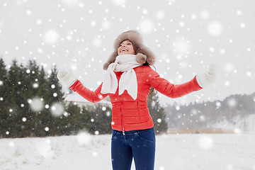 Image showing happy woman in winter fur hat having fun outdoors