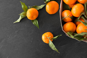 Image showing close up of mandarins on slate table top