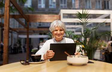 Image showing senior woman with tablet pc and coffee at cafe