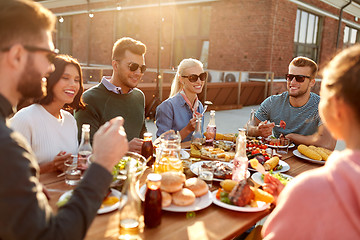 Image showing friends having dinner or bbq party on rooftop