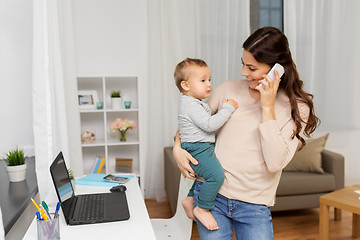 Image showing mother with baby calling on smartphone at home
