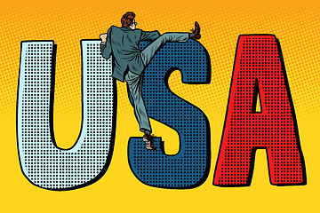 Image showing businessman man climbs across the border. usa word letters