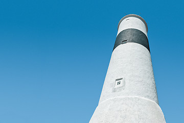 Image showing White lighthouse against blue sky