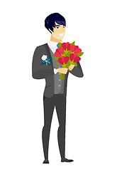 Image showing Asian groom holding a bouquet of flowers