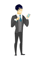 Image showing Asian groom holding a mobile phone.