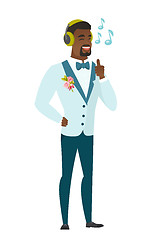 Image showing Groom listening to music in headphones.