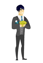 Image showing Happy asian groom holding money.