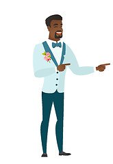 Image showing Young african-american groom pointing to the side.