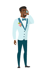 Image showing Groom talking on a mobile phone.